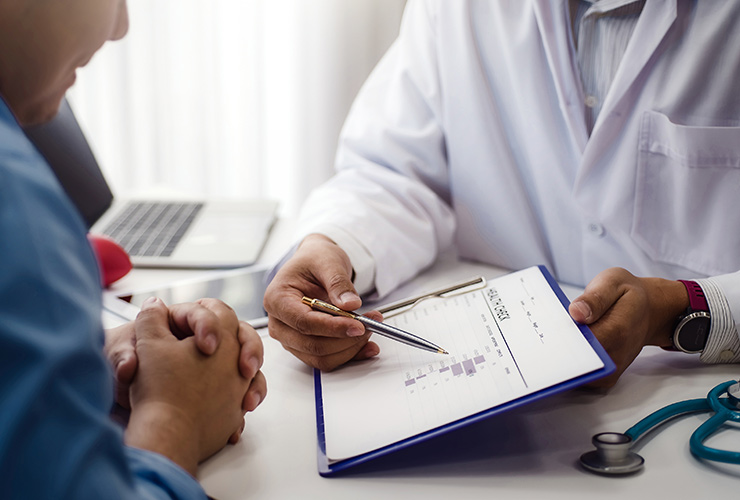 A patient and doctor discuss care at a cancer treatment center