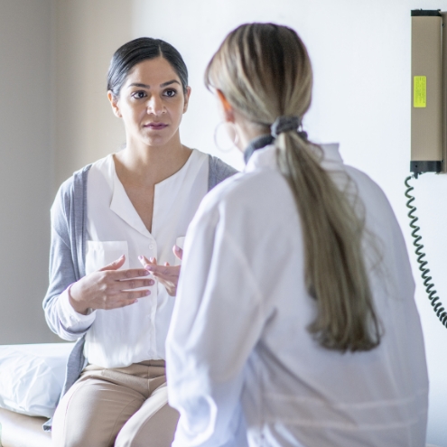 Baptist doctor consulting with patient in a hospital room 