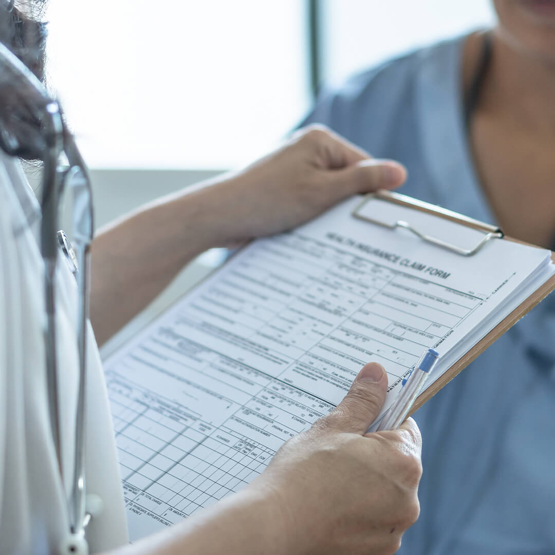 A doctor holding a form on a clipboard