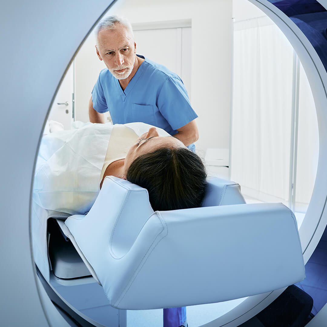 A patient undergoing radiation treatment under a doctor's supervision